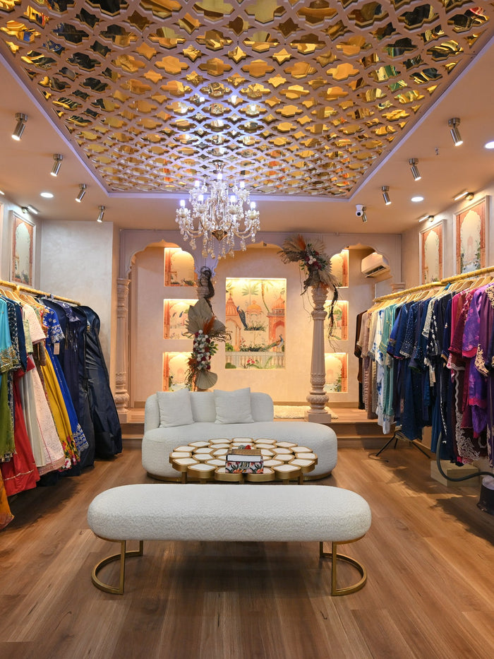 The Summer Bride showroom, with its mirrored gold ceiling, chandelier and rails of colour along both walls