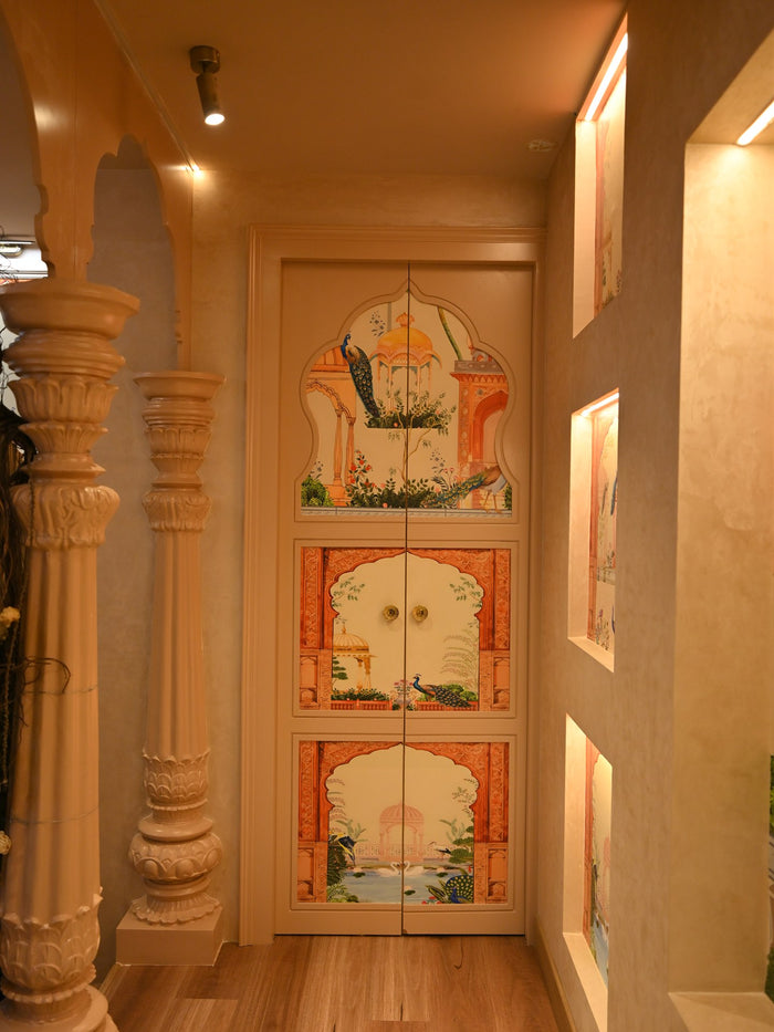 Carved pillars framing the hand-painted doors of the studio corridor
