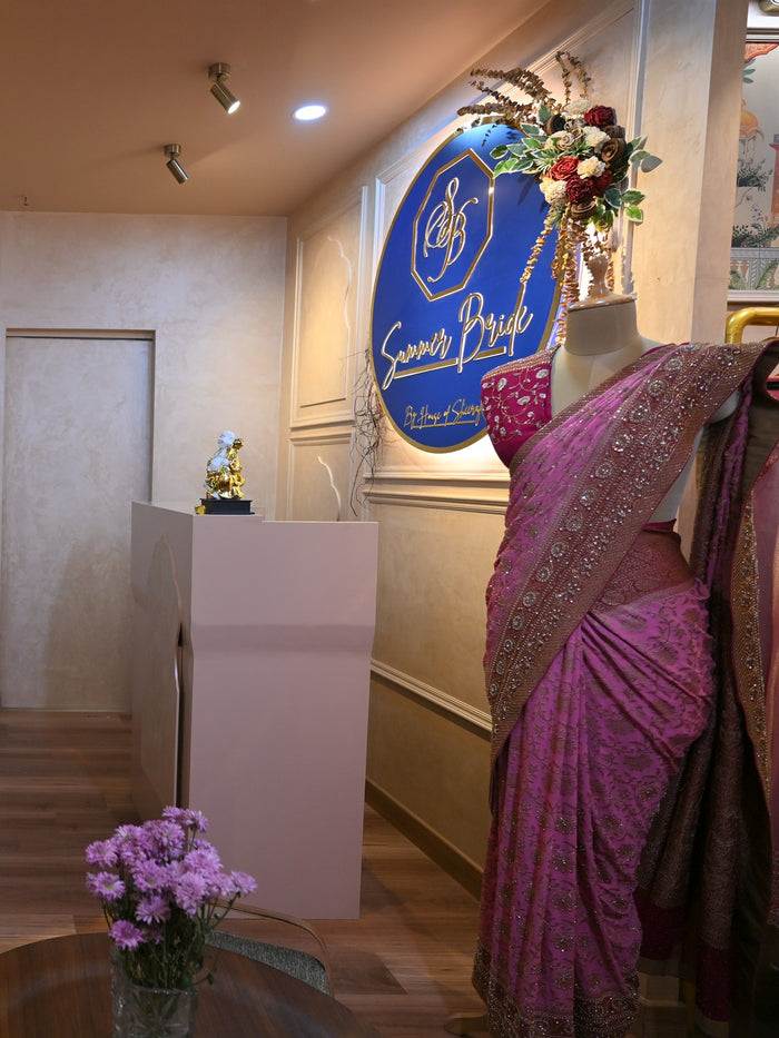 The Summer Bride sign above the studio reception, a draped saree alongside it