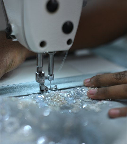 A sewing machine needle running along a beaded panel