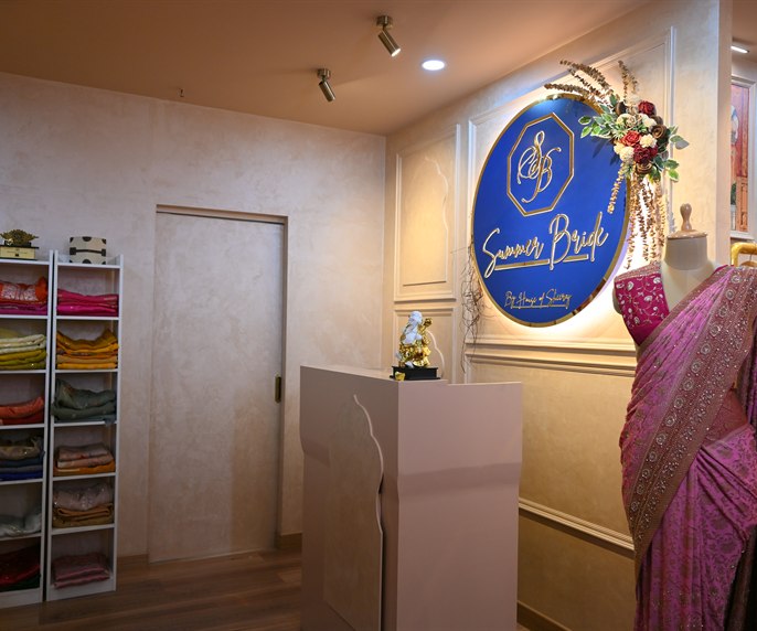 The studio reception, with shelved fabric and the Summer Bride sign